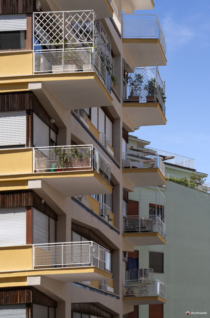 Side detail of the balconies and main facade of the Cassiopea building on Via Archimede