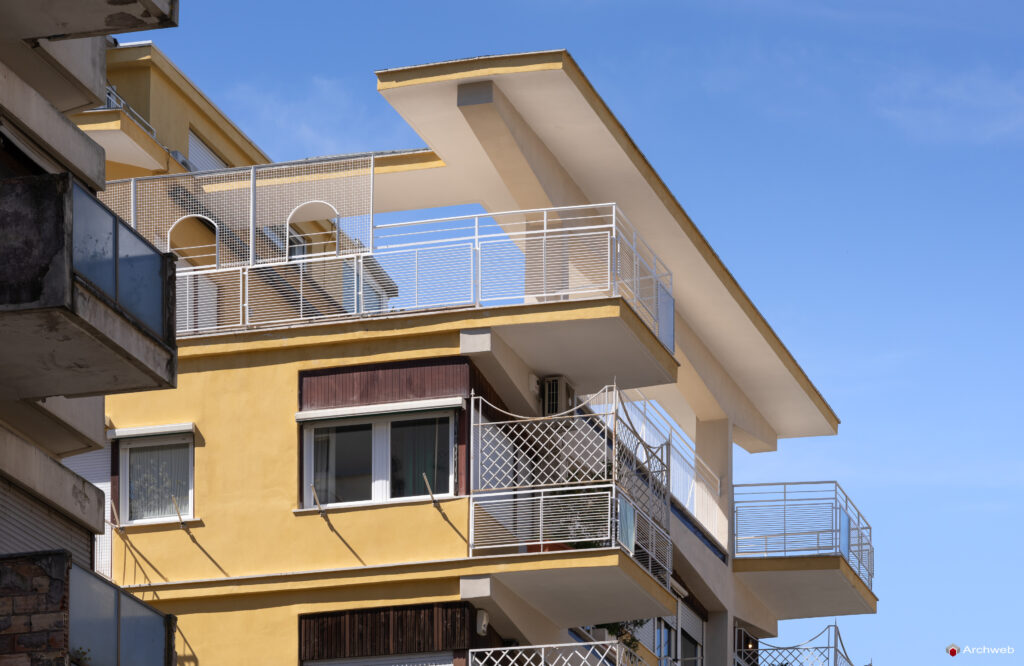 Side detail of the balconies and the connection to the sky of the Cassiopea building on Via Archimede