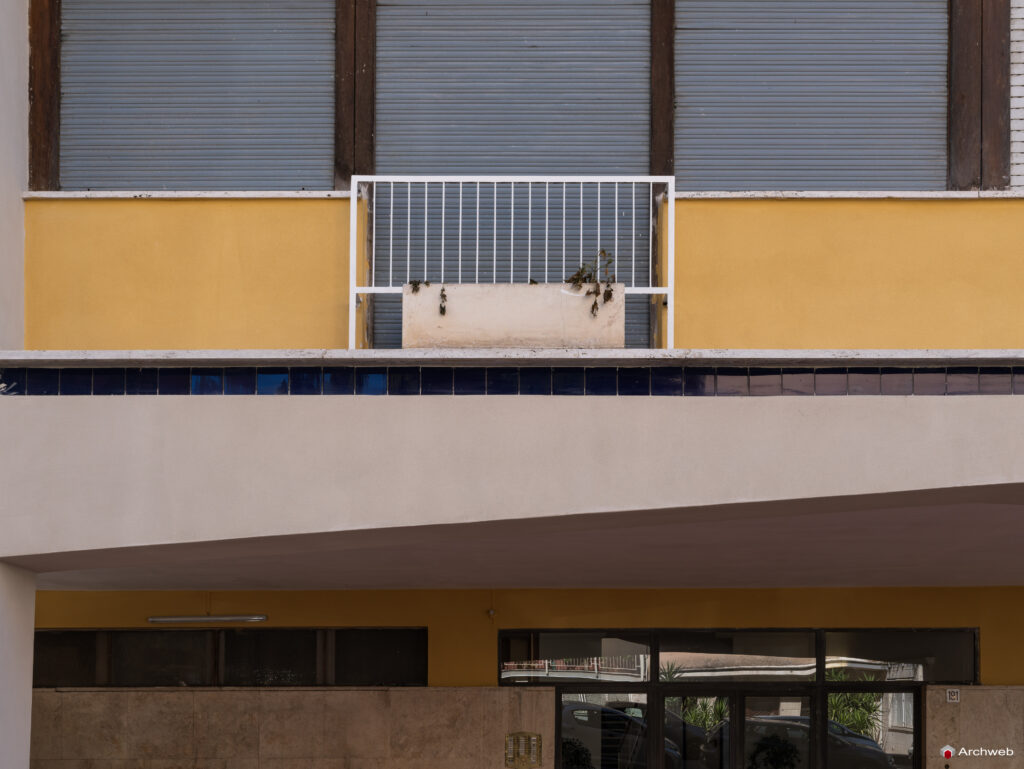 Detail of the main facade of the Cassiopea building seen from Via Archimede