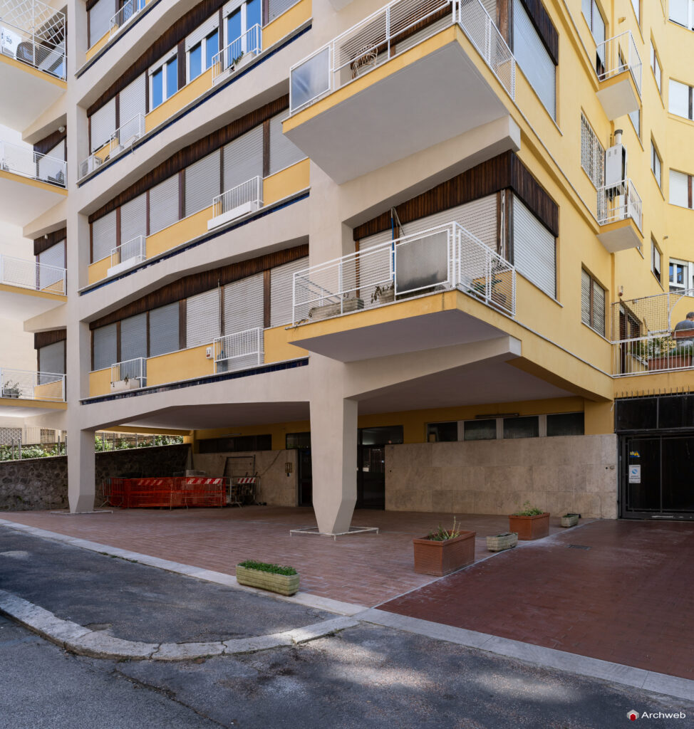 Detail of the main facade of the Cassiopea building seen from Via Archimede